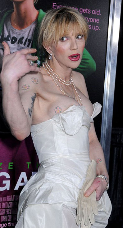 Courtney Love almost pops out of her dress