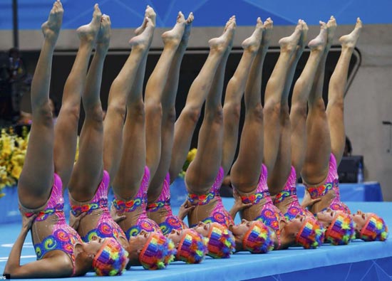 Canada's team line up and point their toes in the air