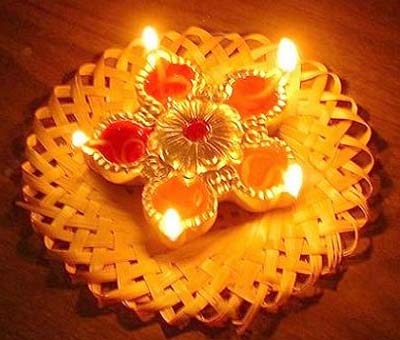 Diwali celebrated with rangolis, prayers, flowers, crackers