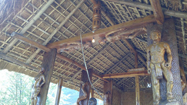 A tribal hut with wooden carvings in Nagaland