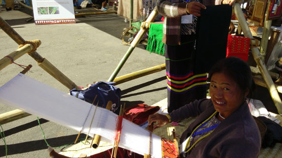 A Naga girl weaving Naga shawl at Hornbill Festival