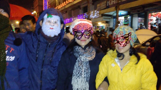 People with colourful masks at Night market at Hornbill Festival