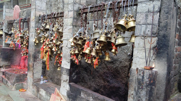 Devotees tie bells and saffron thread to mark their wishes at Kamakhya temple